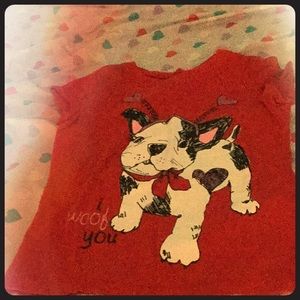 A short sleeve red shirt with a dog in the front